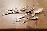 Silver cutlery on a wooden table