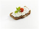 Bread topped with cottage cheese, tomato and basil