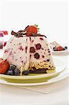 Ice cream bombe with berries, partly slices