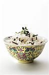 Wild rice in an Asian bowl against a white background