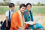 Farmer family using a laptop, Sohna, Haryana, India