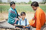 Rural couple teaching their daughter, Sohna, Haryana, India