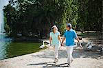 Mature couple walking in a park and smiling, Lodi Gardens, New Delhi, India