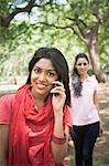 Woman talking on a mobile phone, Lodi Gardens, New Delhi, Delhi, India