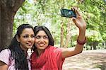 Friends taking a picture of themselves with a mobile phone, Lodi Gardens, New Delhi, Delhi, India