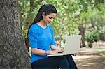 Woman using a laptop in a park, Lodi Gardens, New Delhi, Delhi, India