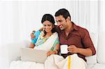 South Indian couple using a laptop