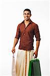 South Indian man carrying shopping bags