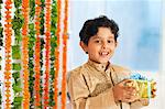 Boy holding a gift on Diwali