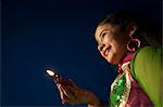 Girl holding an oil lamp on Diwali