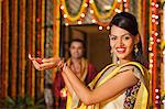 Woman holding an oil lamp on Diwali