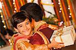 Boy hugging his father on Diwali