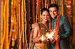 Couple burning fire crackers on Diwali