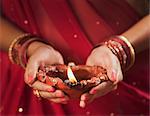 Woman holding an oil lamp on Diwali