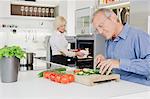 Senior couple preparing healthy meal in kitchen