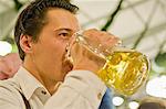 Man drinking from beer mug on the Oktoberfest in Munich, Bavaria, Germany