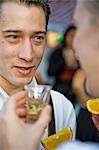 Couple drinking Tequila on the Oktoberfest in Munich, Bavaria, Germany