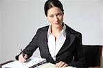 Businesswoman working on documents at desk