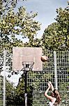 Teenage girl throwing basketball