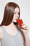 Brunette young woman drinking tomato juice