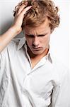 Pensive young man with curly hair