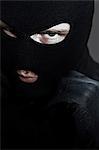 Criminal putting on a balaclava