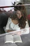 Brunette young woman reading book