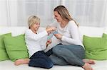 Mother and son playing cards on couch