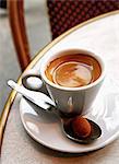 Expresso and chocolate truffle on a table in a Bistro