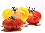 Half a yellow and red tomato and a Coeur de boeuf tomato