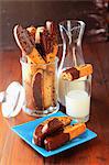 Raisin Croquants dipped in chocolate,glass and jug of milk