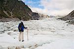 Female tourist walking on Fox Glacier, Westland National Park, UNESCO World Heritage Site, South Island, New Zealand, Pacific