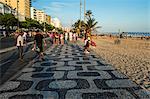 People walking along the sidewalk at Ipanema Beach, Rio de Janeiro, Brazil, South America