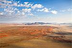 Aerial view from hot air balloon over magnificent desert landscape of sand dunes, mountains and Fairy Circles, Namib Rand game reserve Namib Naukluft Park, Namibia, Africa