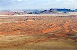 Aerial view from hot air balloon over magnificent desert landscape of sand dunes, mountains and Fairy Circles, Namib Rand game reserve Namib Naukluft Park, Namibia, Africa