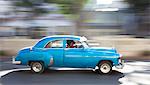 Panned' shot of old American car to capture sense of movement, Prado, Havana Centro, Cuba, West Indies, Central America