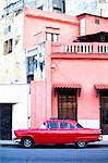 Red vintage American car parked on a street in Havana Centro, Havana, Cuba, West Indies, Central America