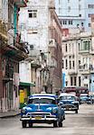 Vintage American cars used as local taxis, driving down Avenue Colon during afternoon rush hour, Havana Centro, Havana, Cuba, West Indies, Central America