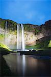 Seljalandsfoss waterfall lit up at night, Southern Region, Iceland, Polar Regions