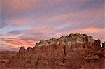 Orange clouds at dawn over the badlands, Goblin Valley State Park, Utah, United States of America, North America