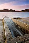 Usk Reservoir outflow and boat in winter, Brecon Beacons National Park, Carmarthenshire, Wales, United Kingdom, Europe