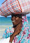 Woman carrying package on head, Zanzibar, Tanzania, East Africa, Africa