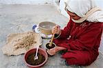 Woman grinding spices, Douz, Kebili, Tunisia, North Africa, Africa