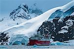 Cruise ship in front of the glaciers and icefields of Danco Island, Antarctica, Polar Regions