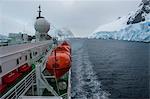 Cruise ship slowly passing through the Lemaire Channel, Antarctica, Polar Regions