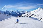 Skiers on Levasset blue piste in winter sunshine, Champagny, La Plagne, French Alps, France, Europe