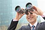 Smiling Businessman Using Binoculars, Reflection