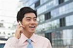 Young Businessman in pink button down shirt on the phone, Beijing, China