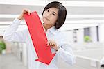 Young Woman Holding Arrow Sign Paper Cut