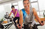 Man smiling and exercising on the exercise bike